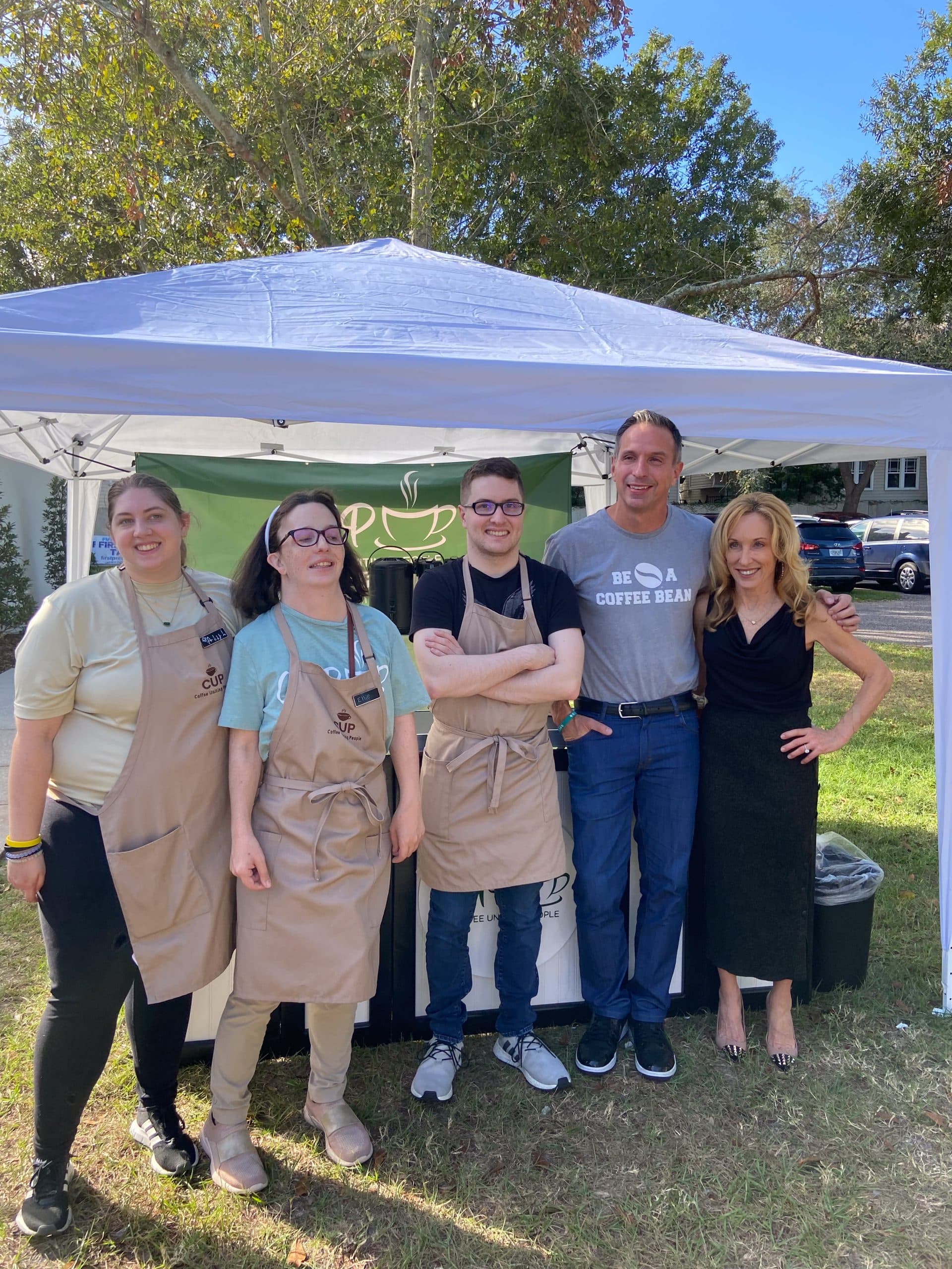CUP pop-up tent at an outdoor event with team members and guests